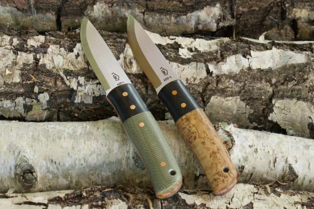The Puukko handmade bushcraft knife shown with forest green Micarta and stabilised curly birch handle scales
